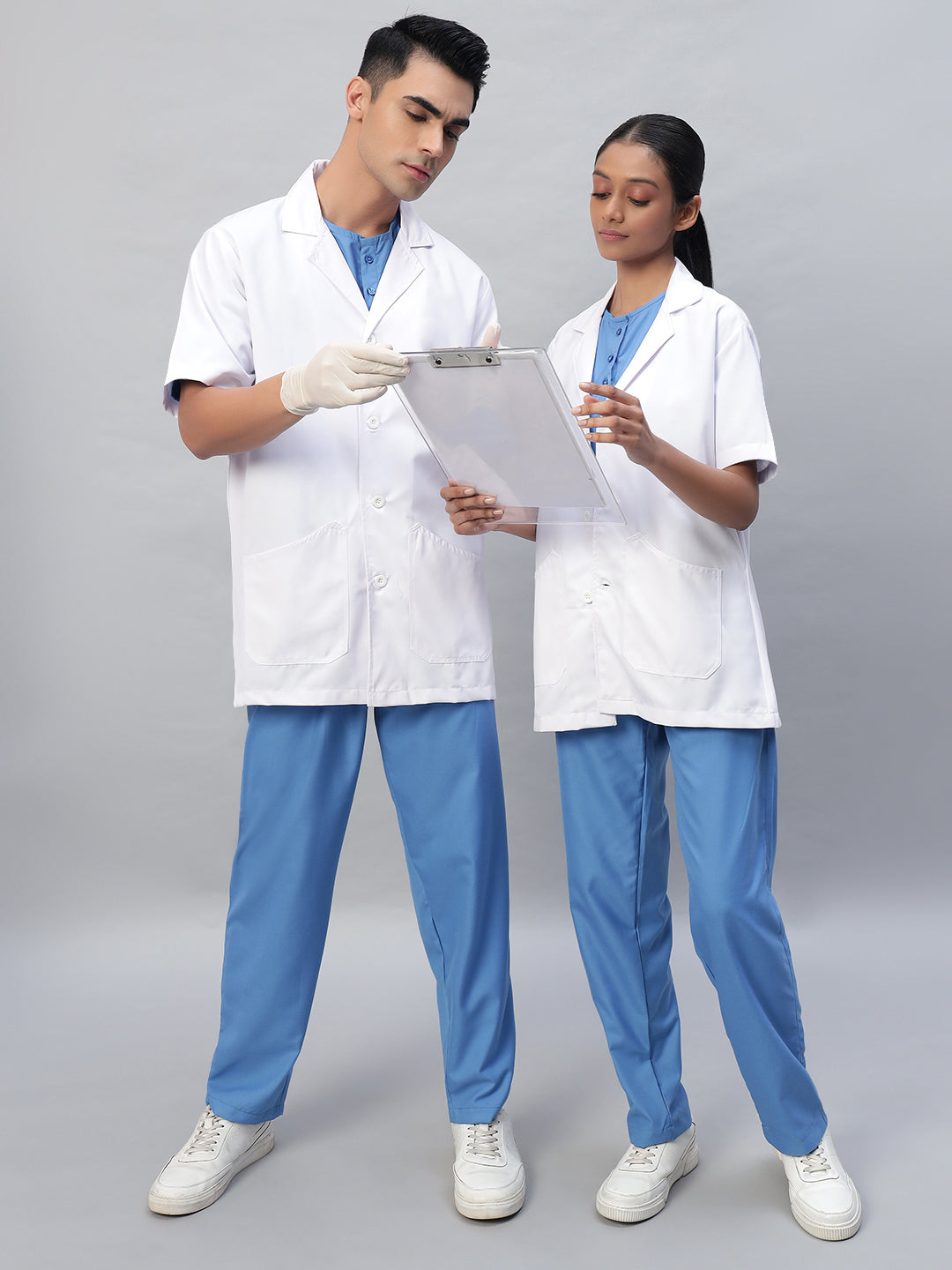 A man and a woman wearing White half-sleeve lab coat