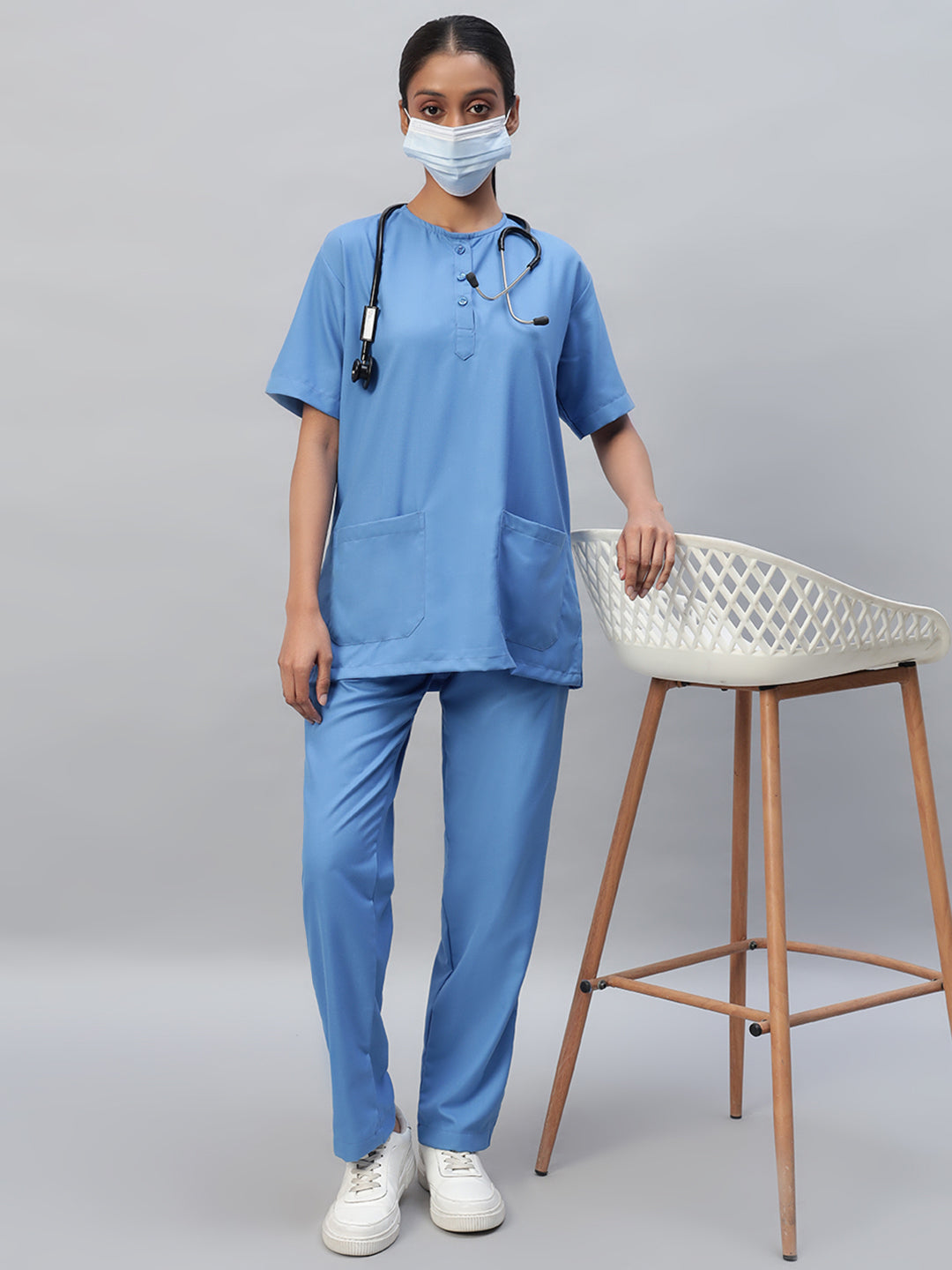 A girl wearing medical scrub suit in sky blue color.