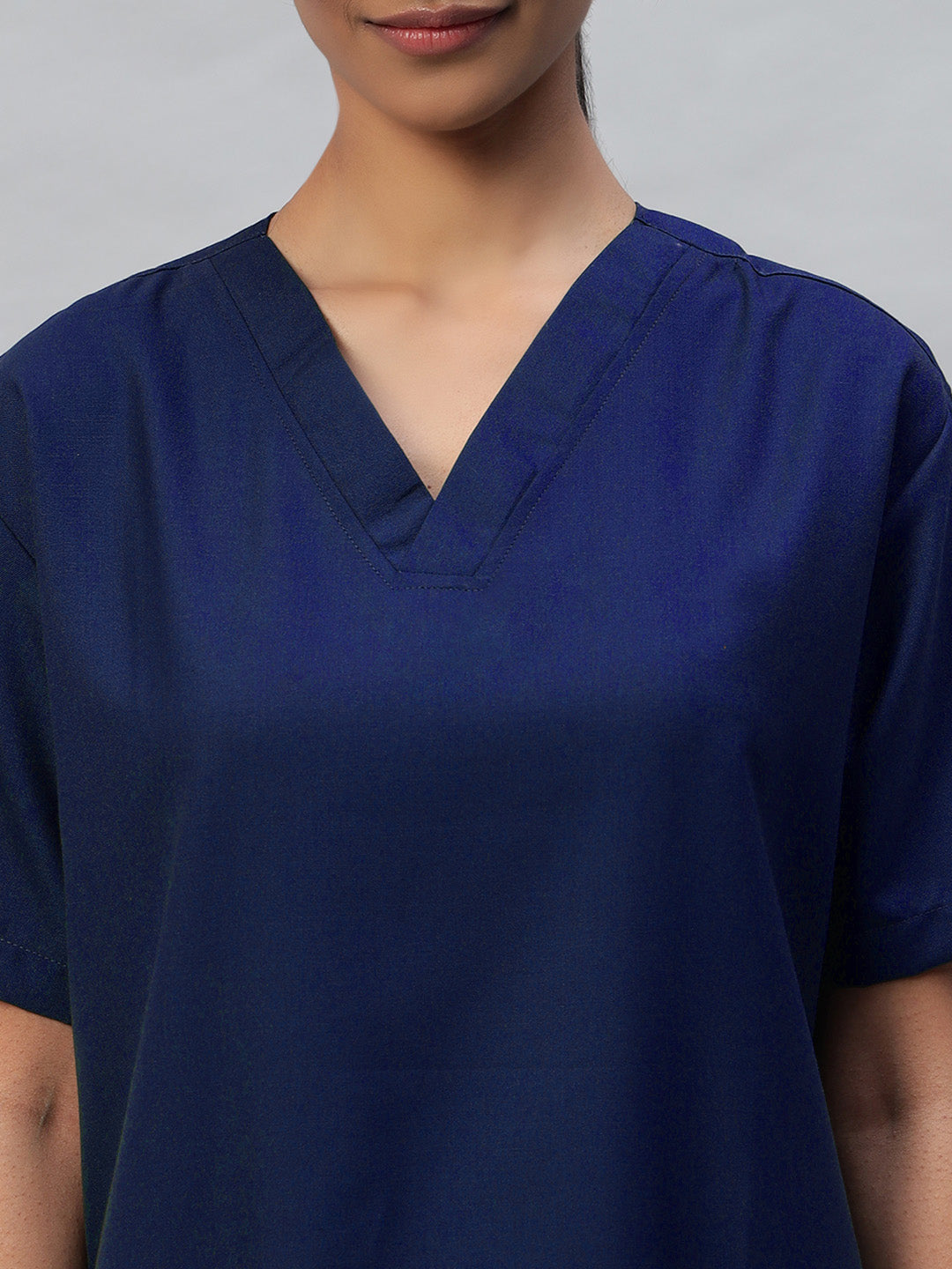 zoomed look of v-neck Navy blue medical scrub for women