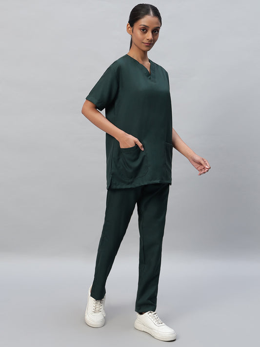 female wearing dark green medical scrubs with a V-neck, half sleeve top and matching pants with drawstrings