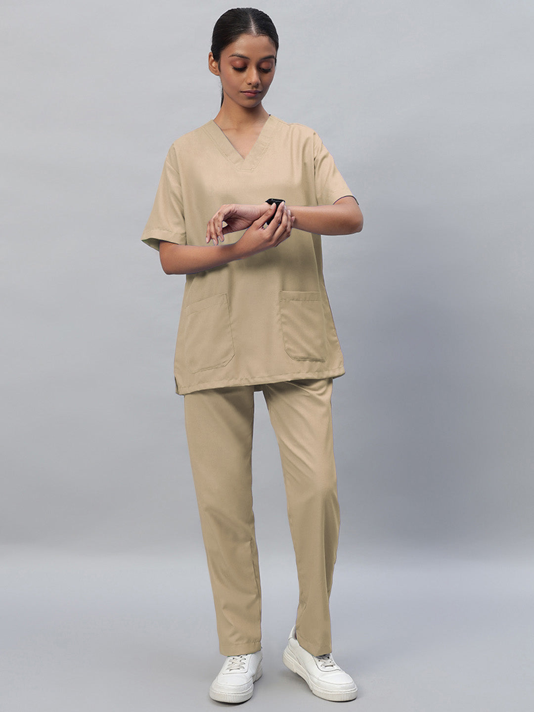 beige V-neck, half sleeve medical scrub top with one front pocket and matching scrub pants with drawstrings.