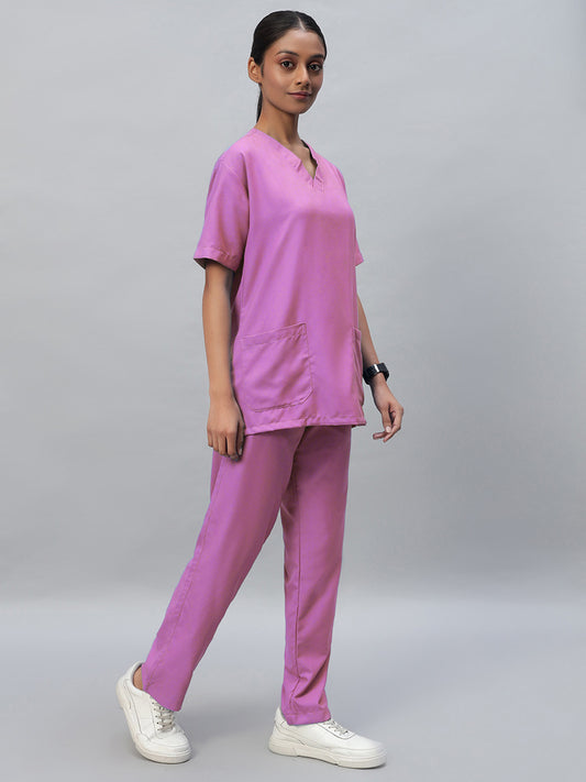 Pink color medical scrubs with a V-neck, half sleeve top and elastic bottom with drawstrings. The outfit includes a front pocket and side pockets.
